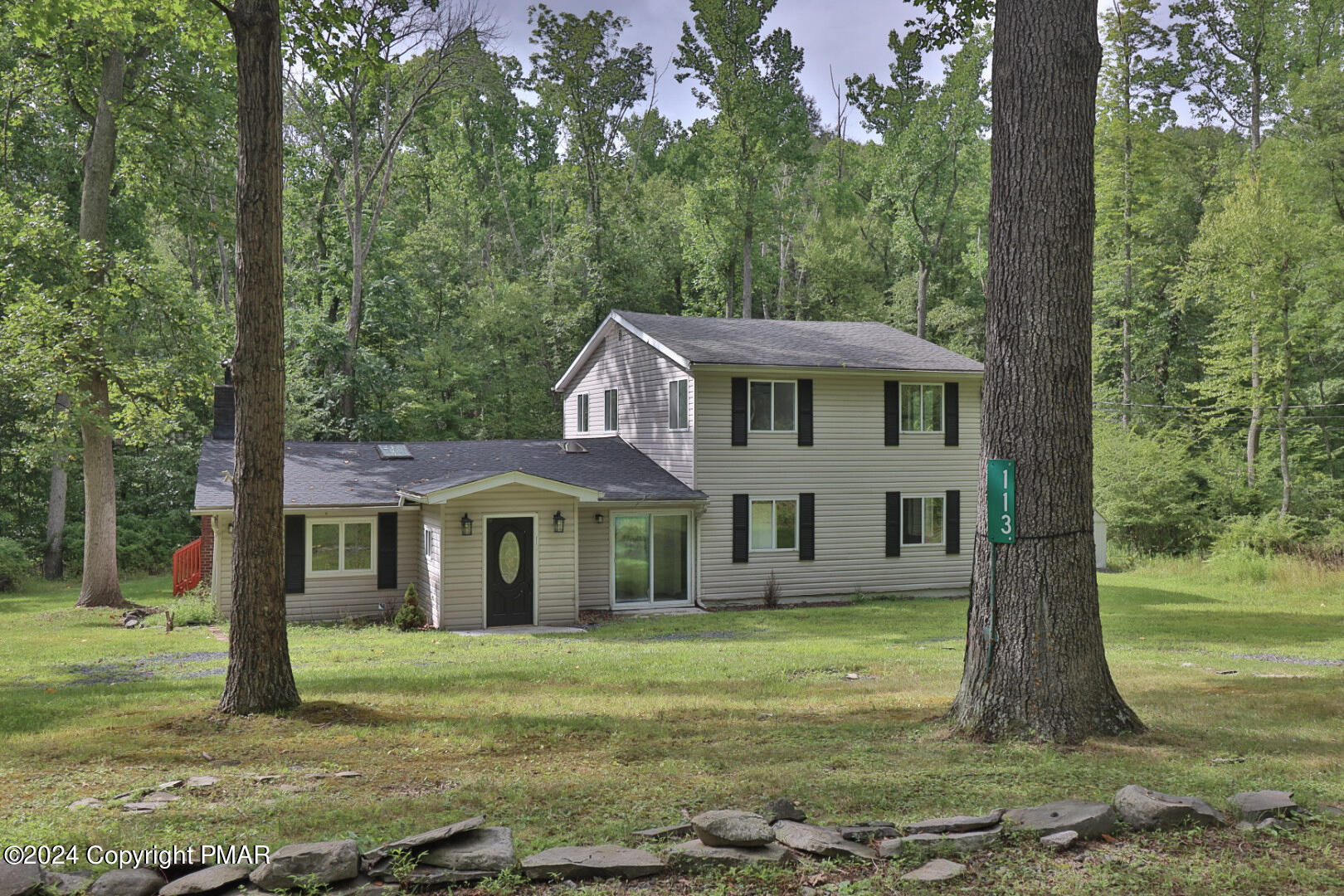 a front view of a house with a garden