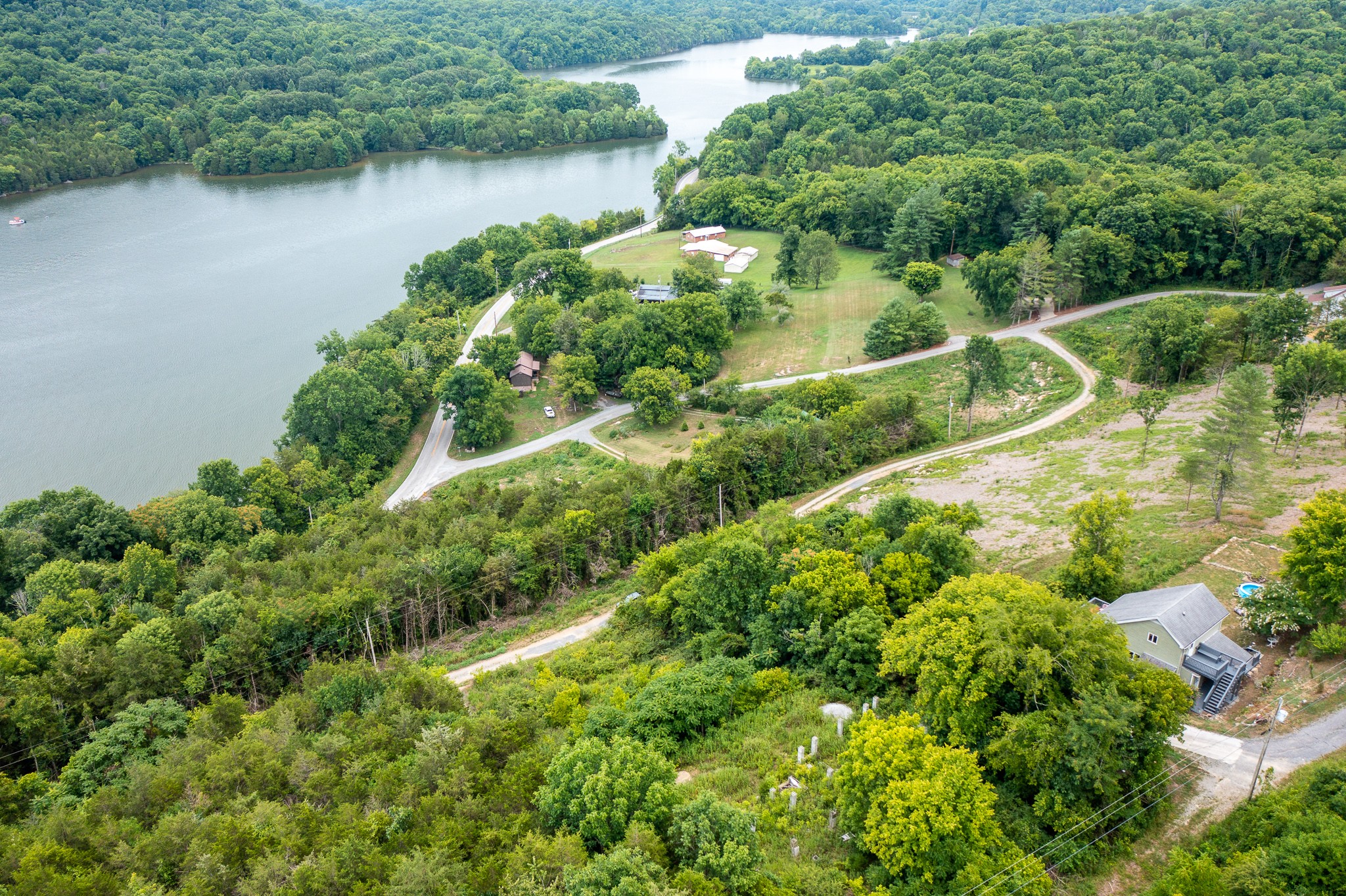 an aerial view of residential house with outdoor space and lake view