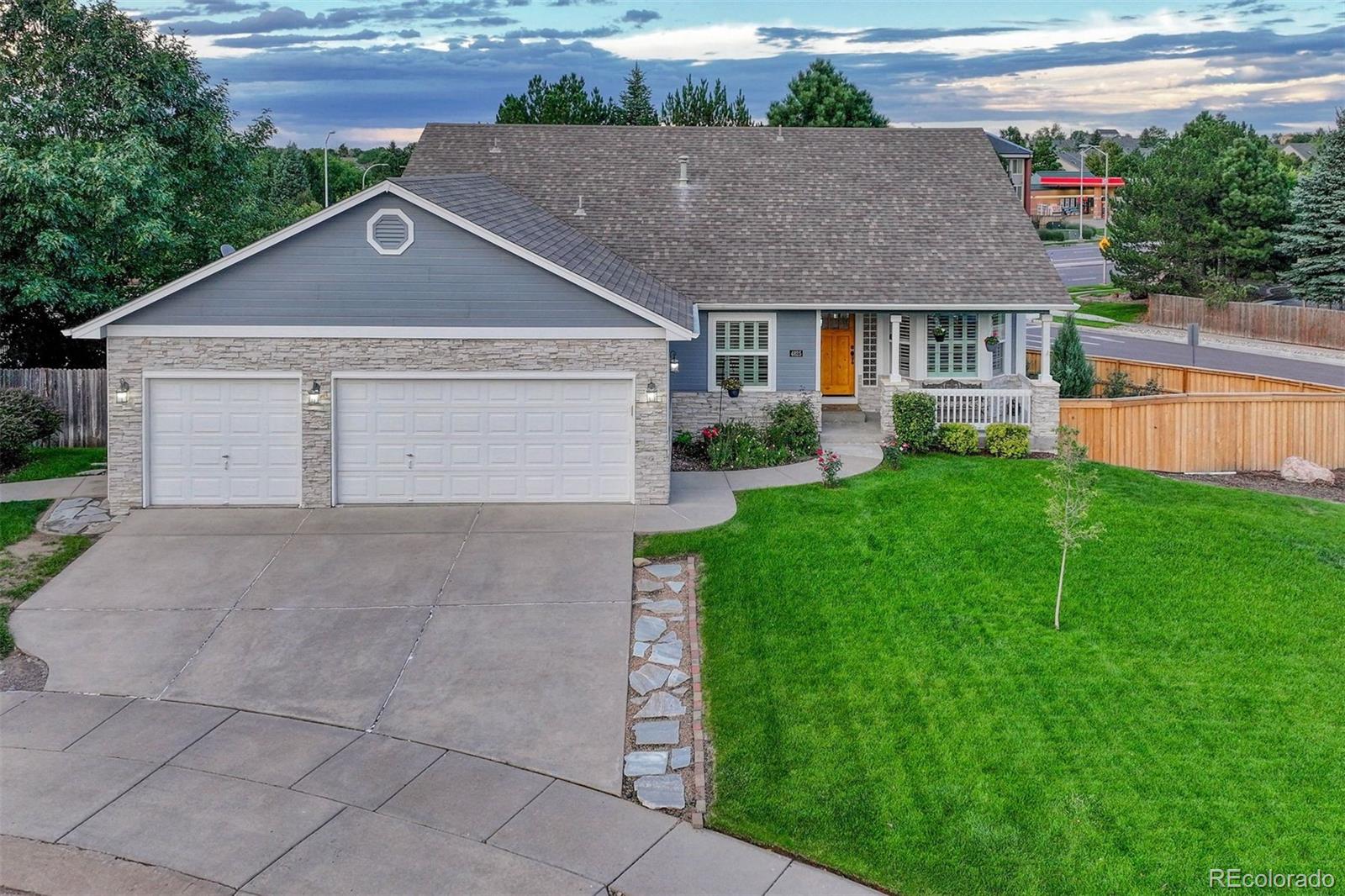 a aerial view of a house with a yard and garage