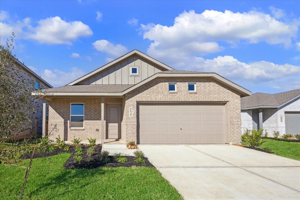 This charming one-story brick home features a classic front elevation with a welcoming entrance. The exterior showcases a timeless brick facade, complemented by neatly manicured landscaping.