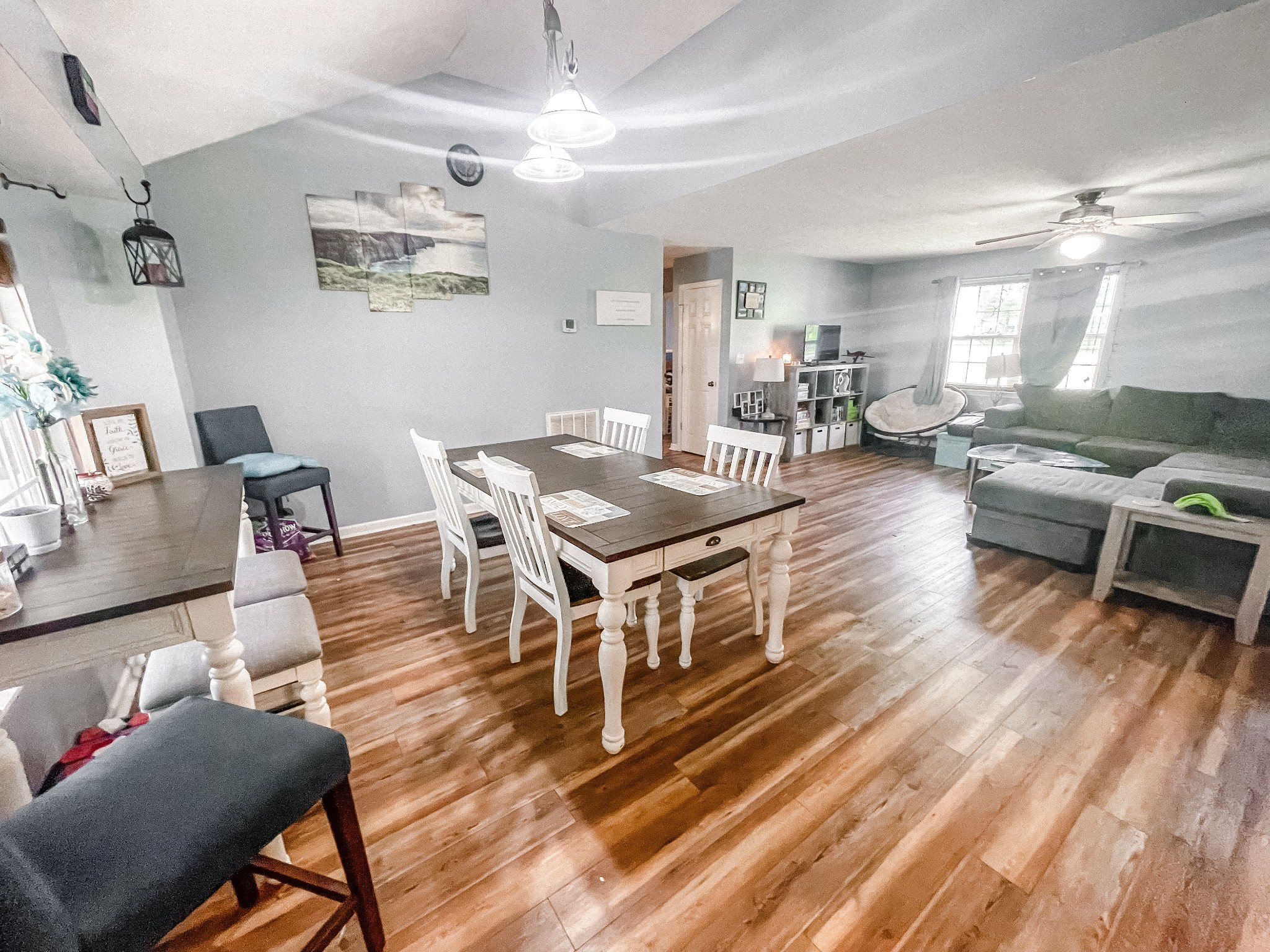 a living room with furniture a flat screen tv and kitchen view