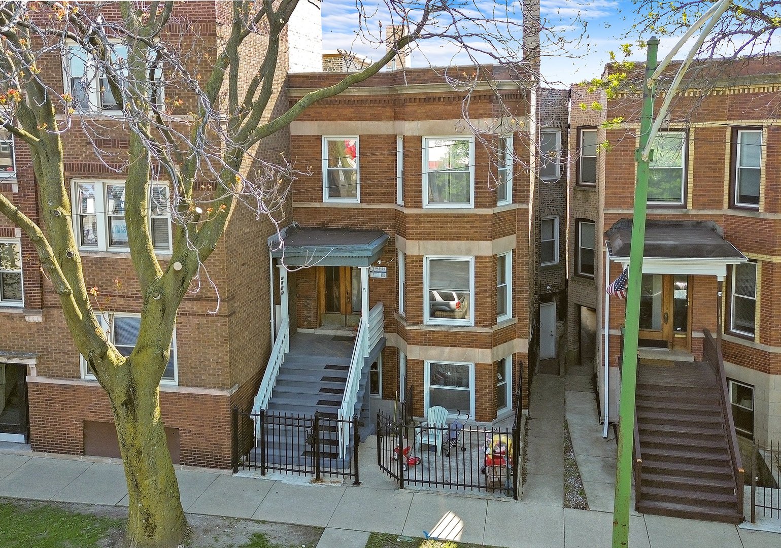 a front view of a house with a tree