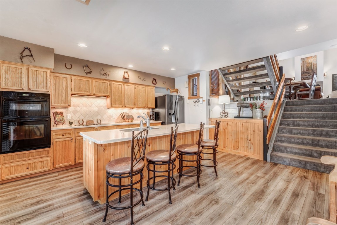 a kitchen with stainless steel appliances a stove a sink dishwasher and a refrigerator