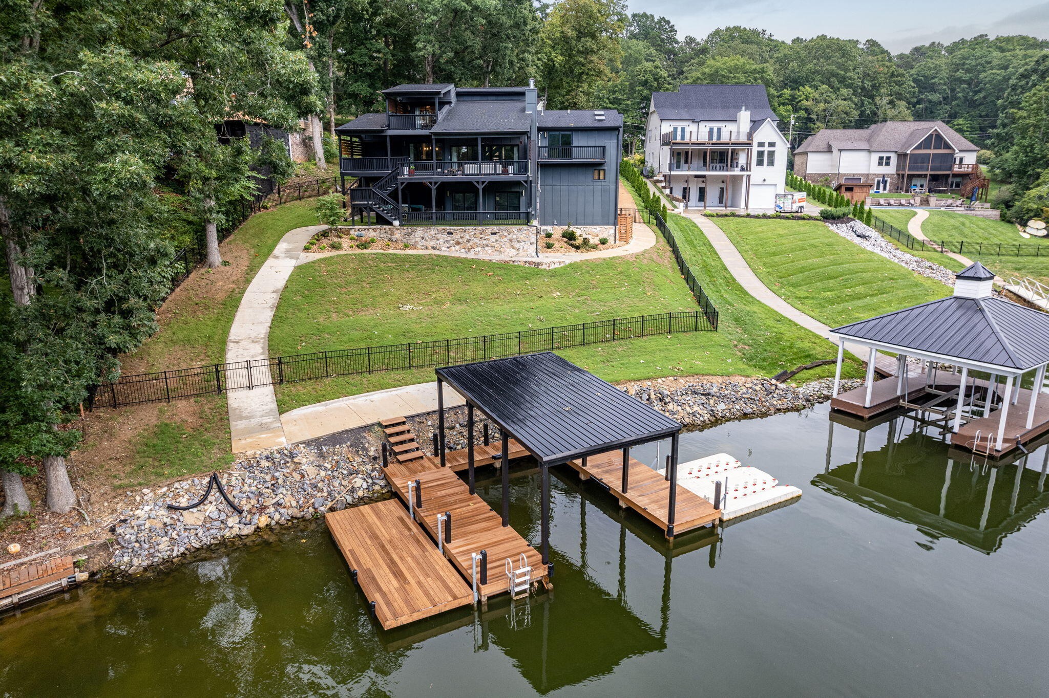 an aerial view of a house with swimming pool patio and lake view