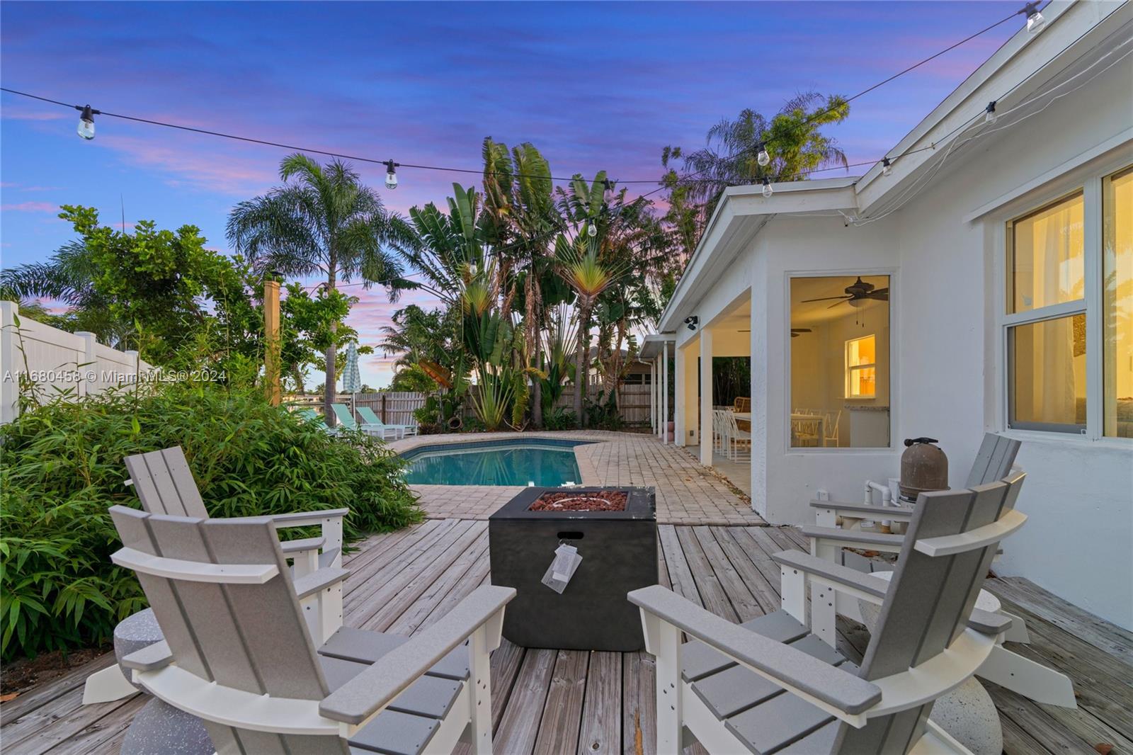 a view of a patio with couches table and chairs and potted plants