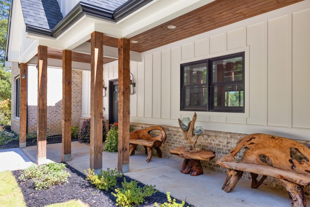 a building outdoor space with patio furniture and potted plants