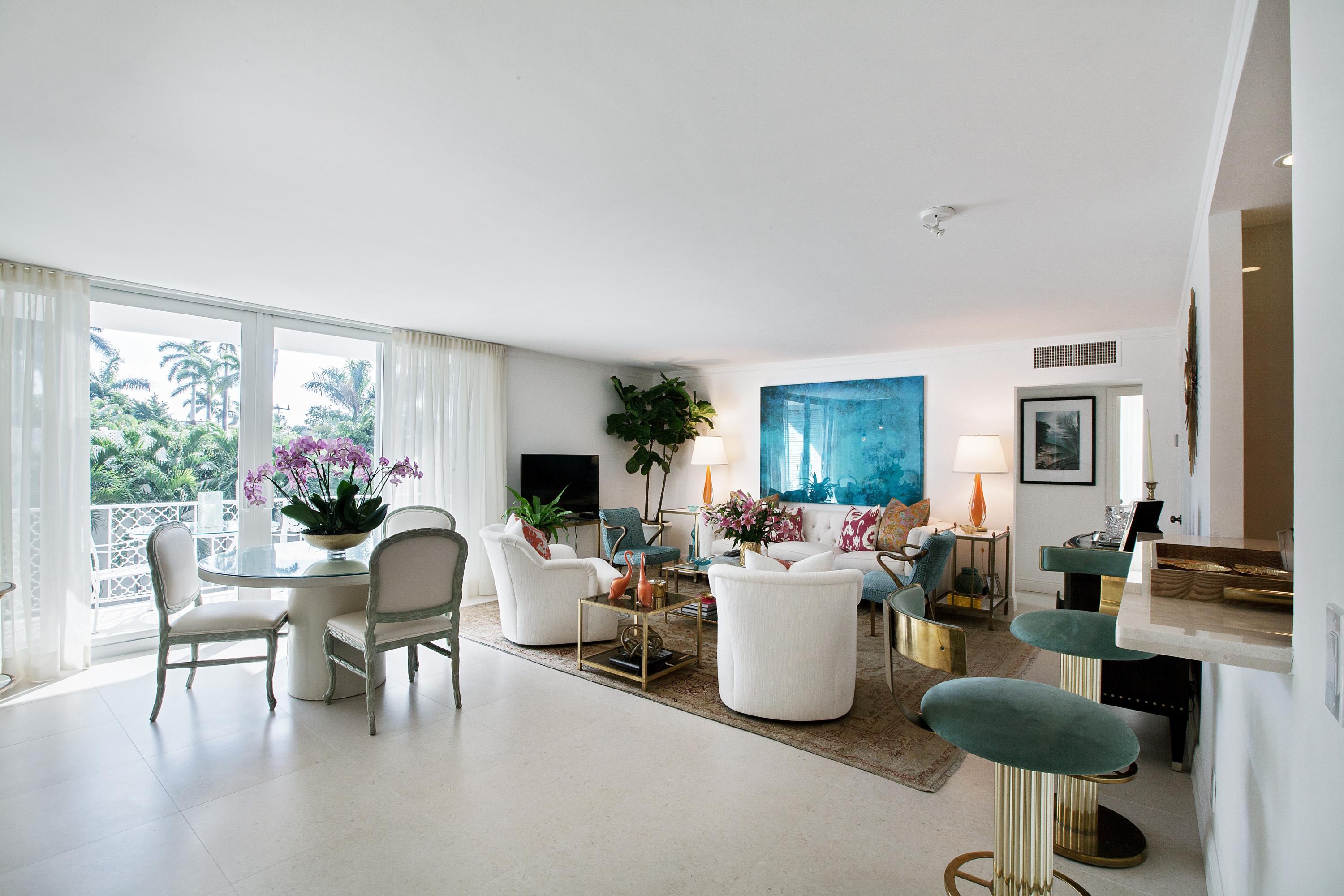 a living room with furniture potted plant a window and a flat screen tv