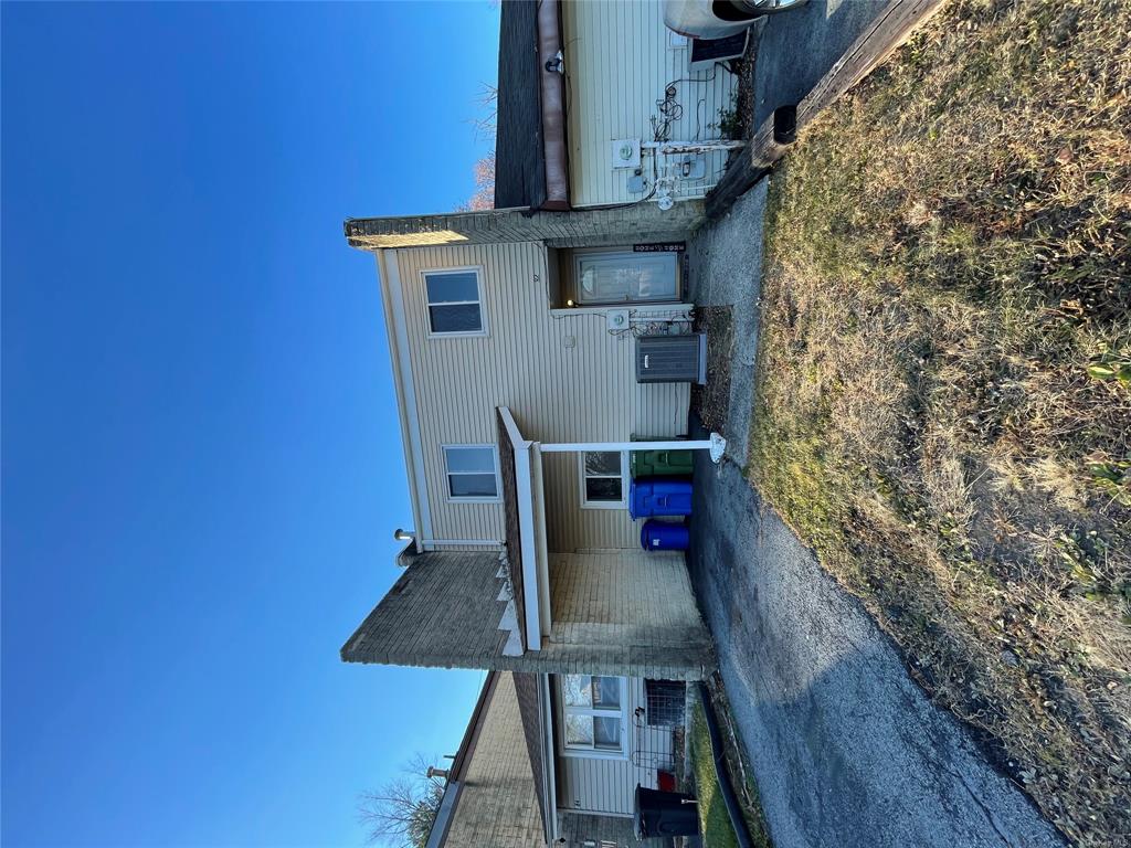 a view of a house with a patio and a yard