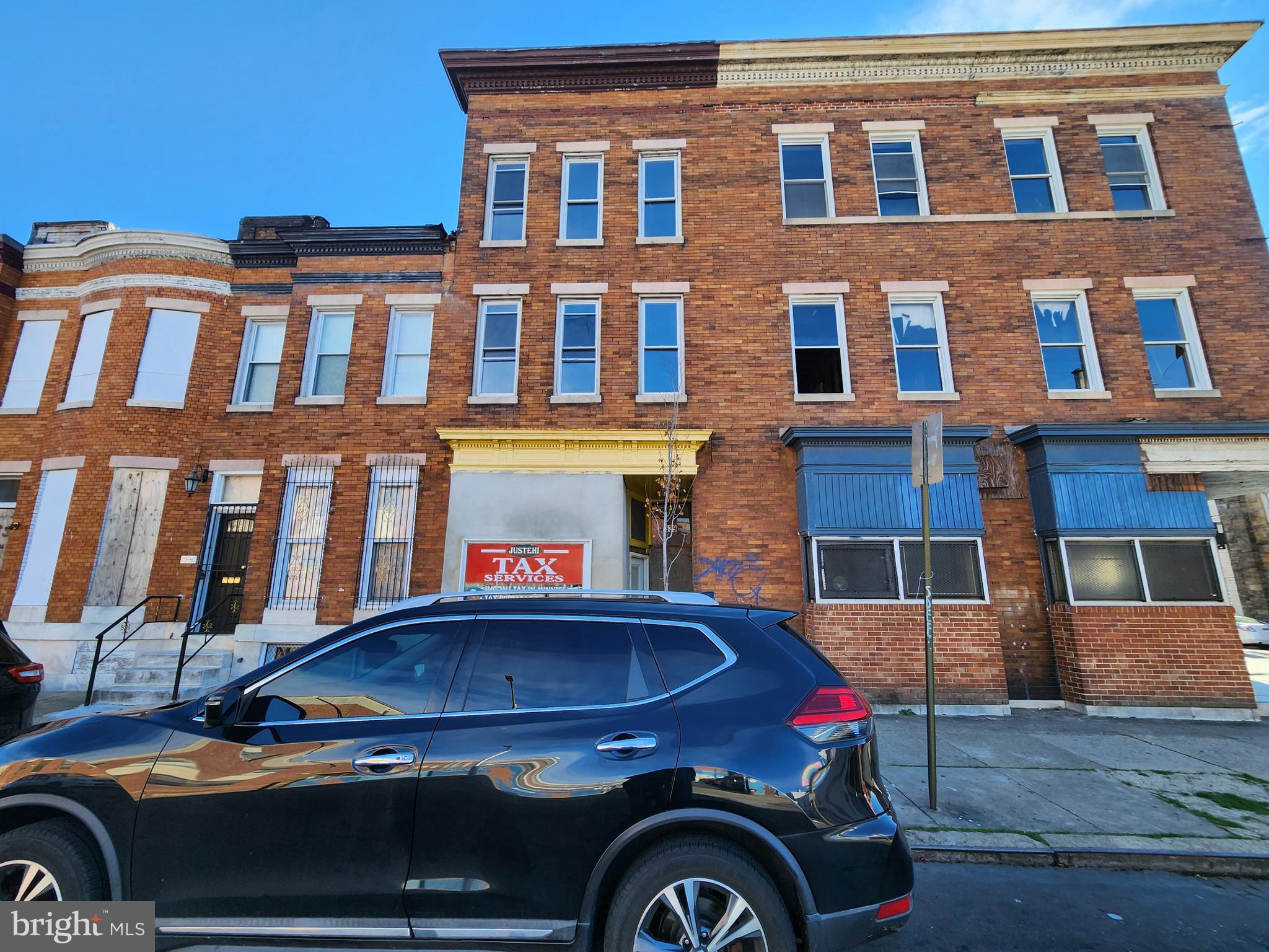 a front view of a house with car parked