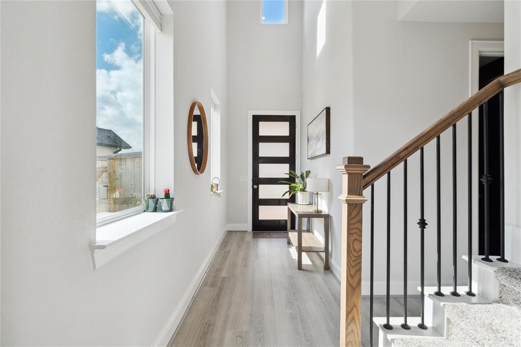 a view of entryway with wooden floor and stairs