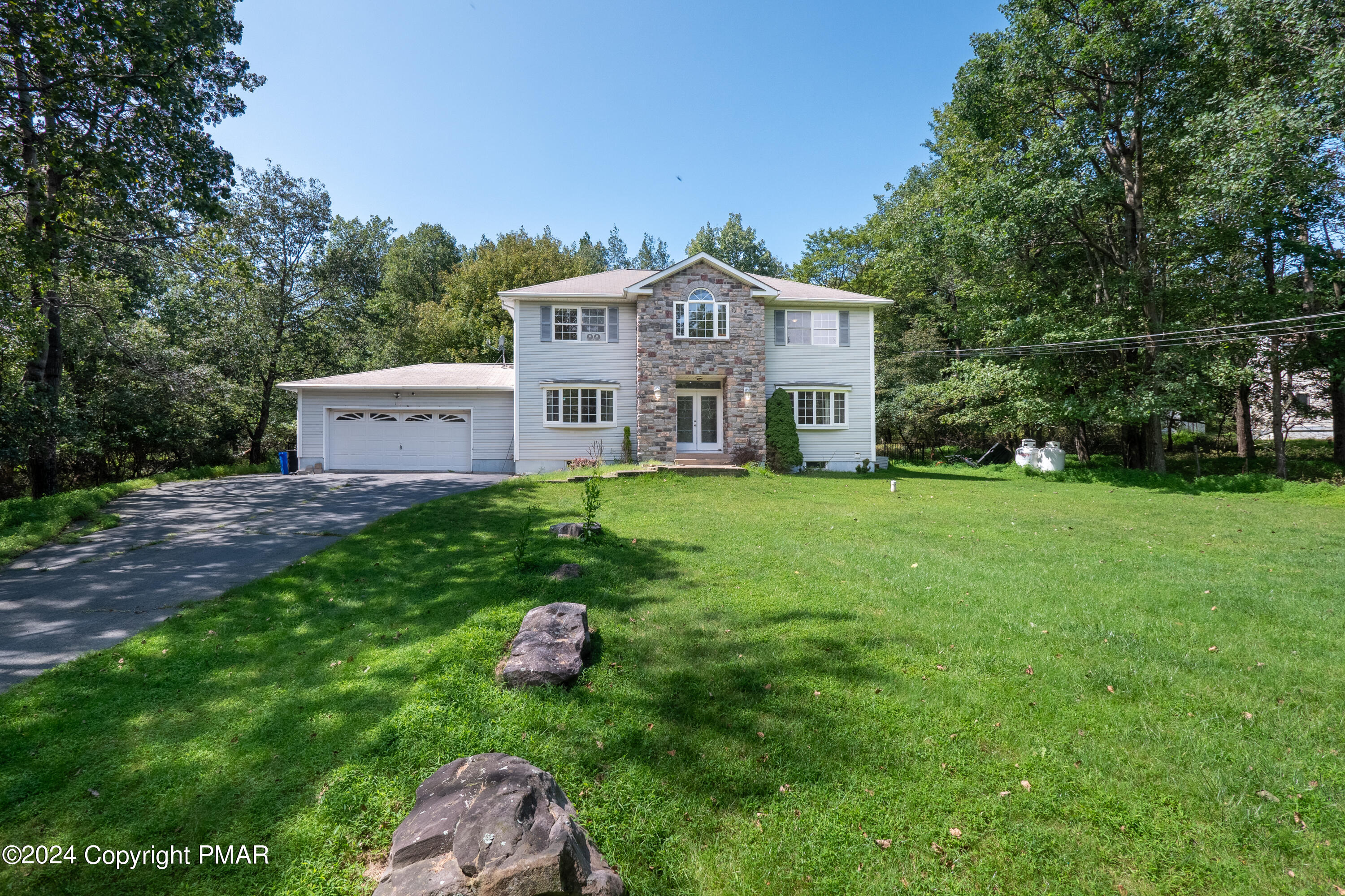 a front view of a house with garden