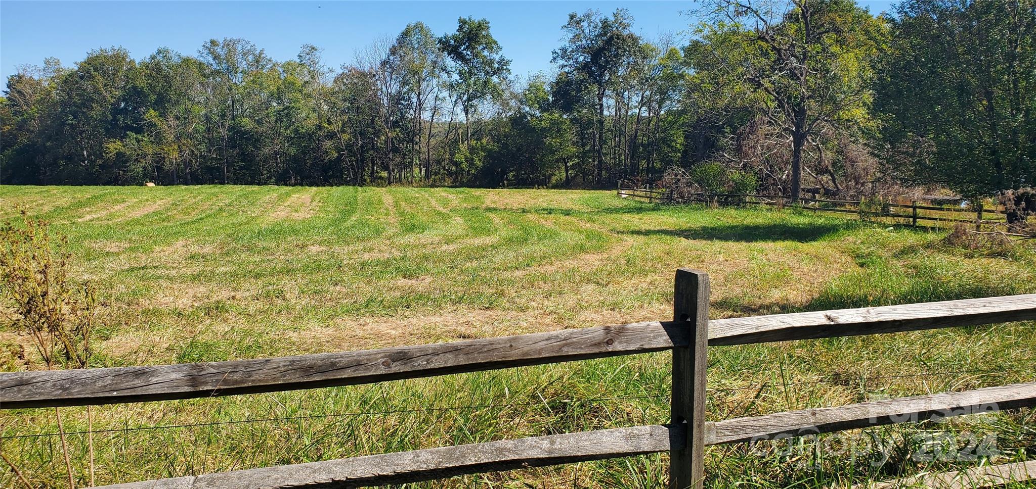 a view of a field with an ocean view