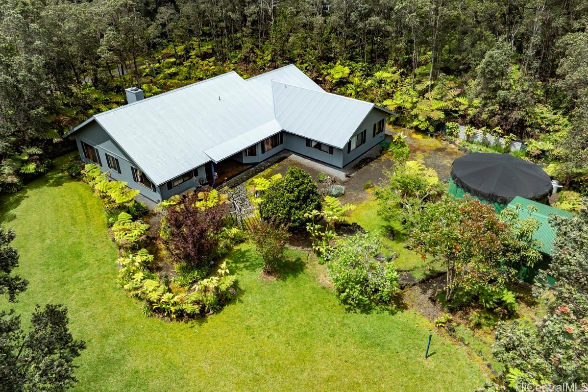 an aerial view of a house with yard swimming pool and outdoor seating