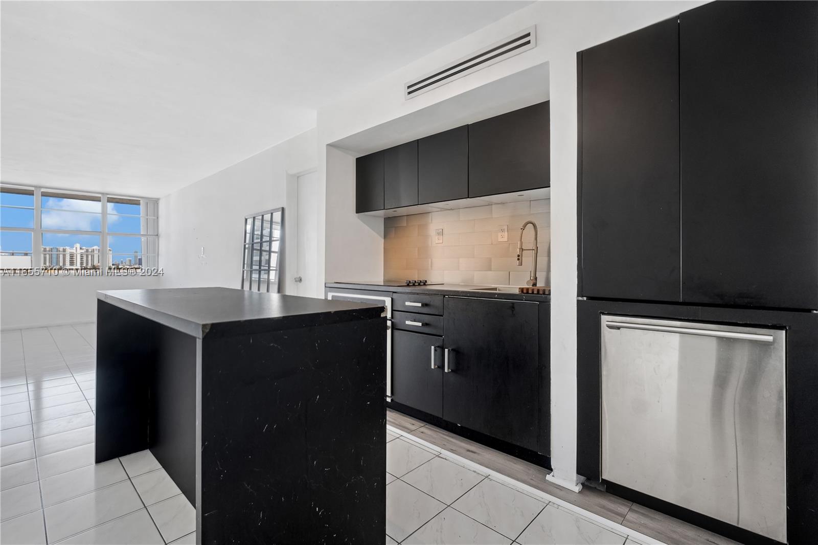 a kitchen with a refrigerator and a sink