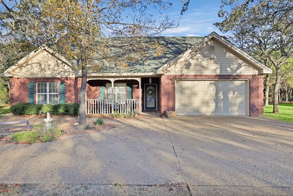 front view of a house with a wooden fence