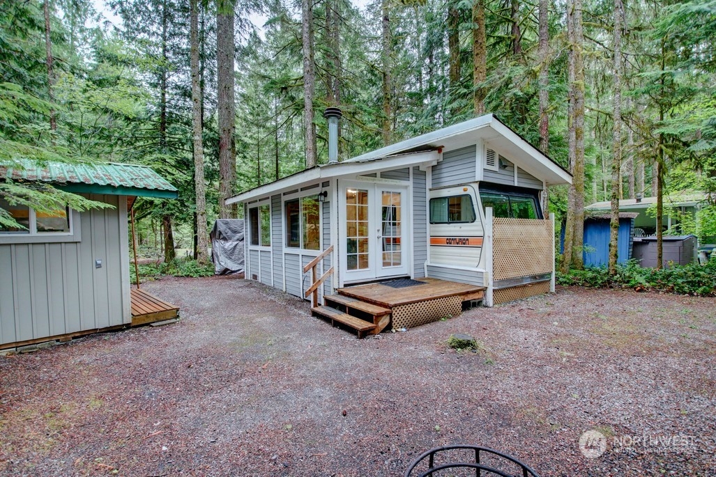 a backyard of a house with barbeque oven and outdoor seating