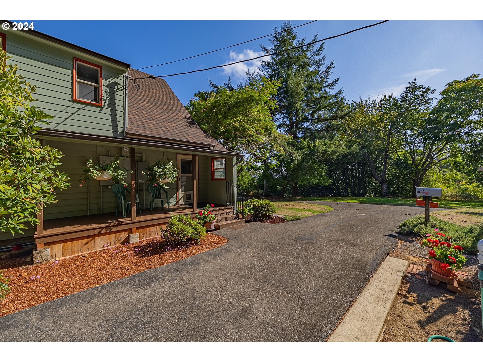 a view of a house with backyard and sitting area