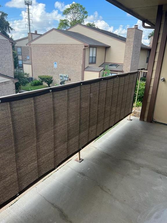 a view of a house with wooden fence