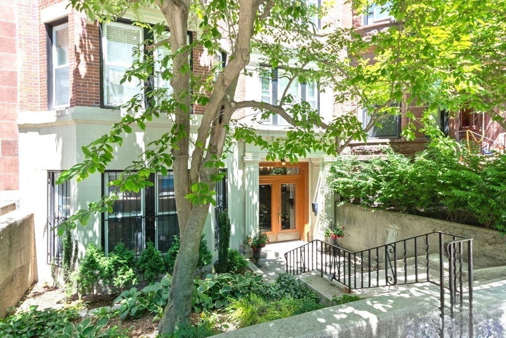 a view of a house with a tree in the background