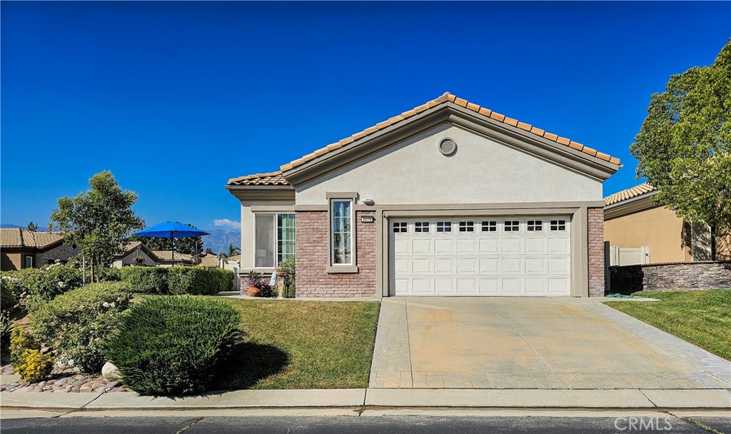 a front view of a house with a yard garage and garage