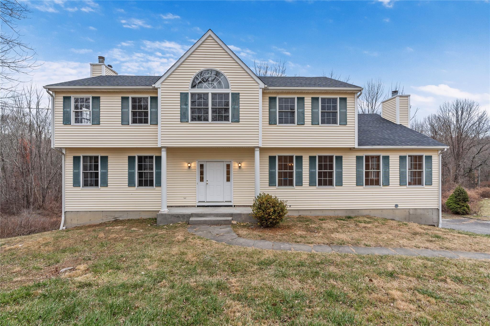 Colonial home featuring a front yard