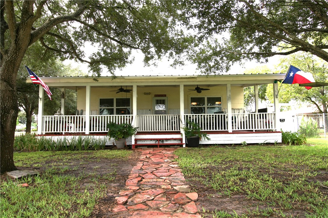 a front view of a house with a yard and table and chairs