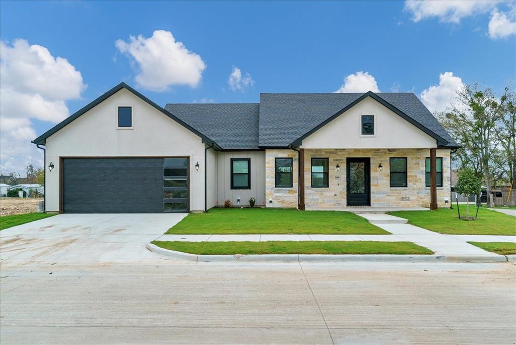 a front view of a house with a yard and garage