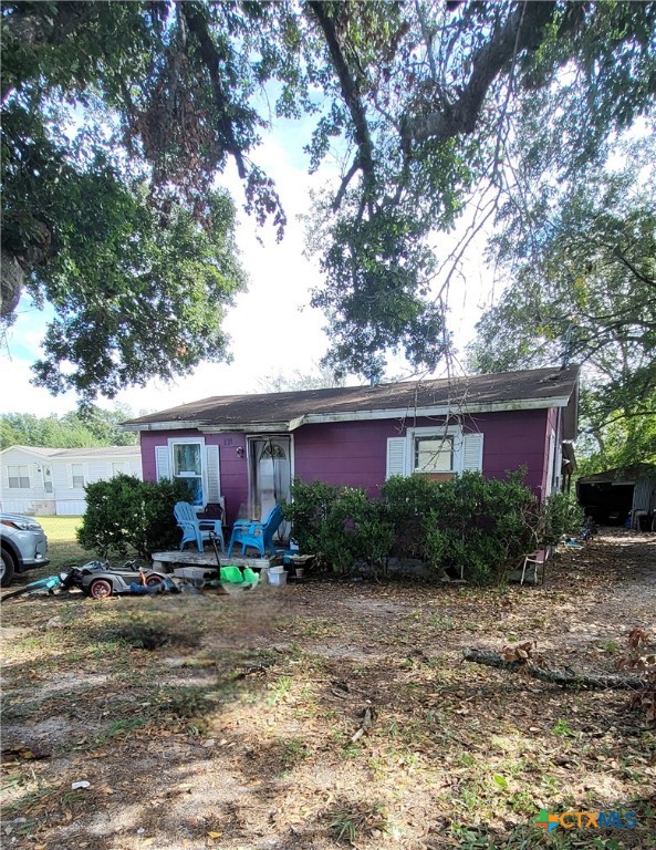 a view of a house with a yard and plants