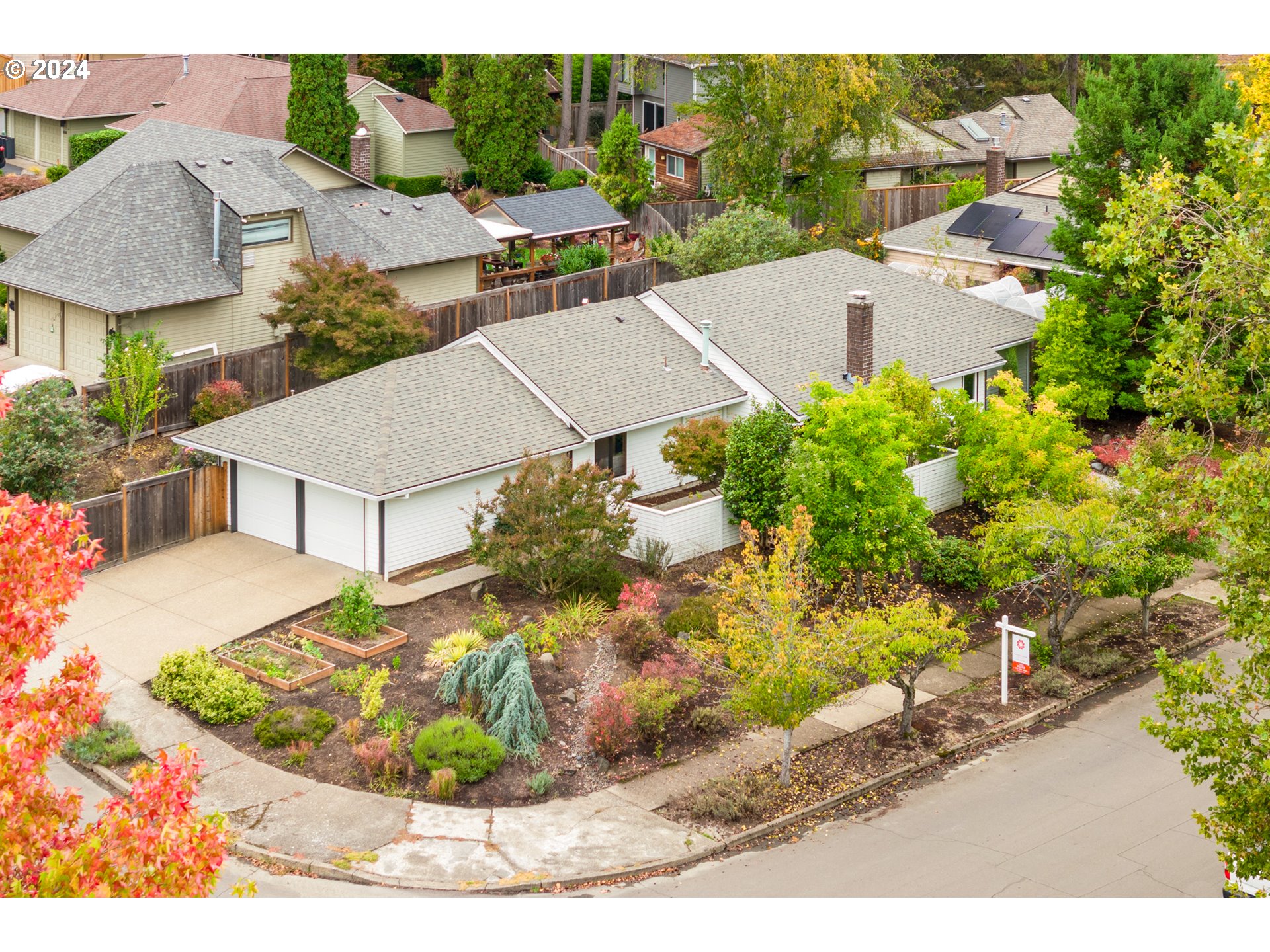 a view of a house with a yard and potted plants