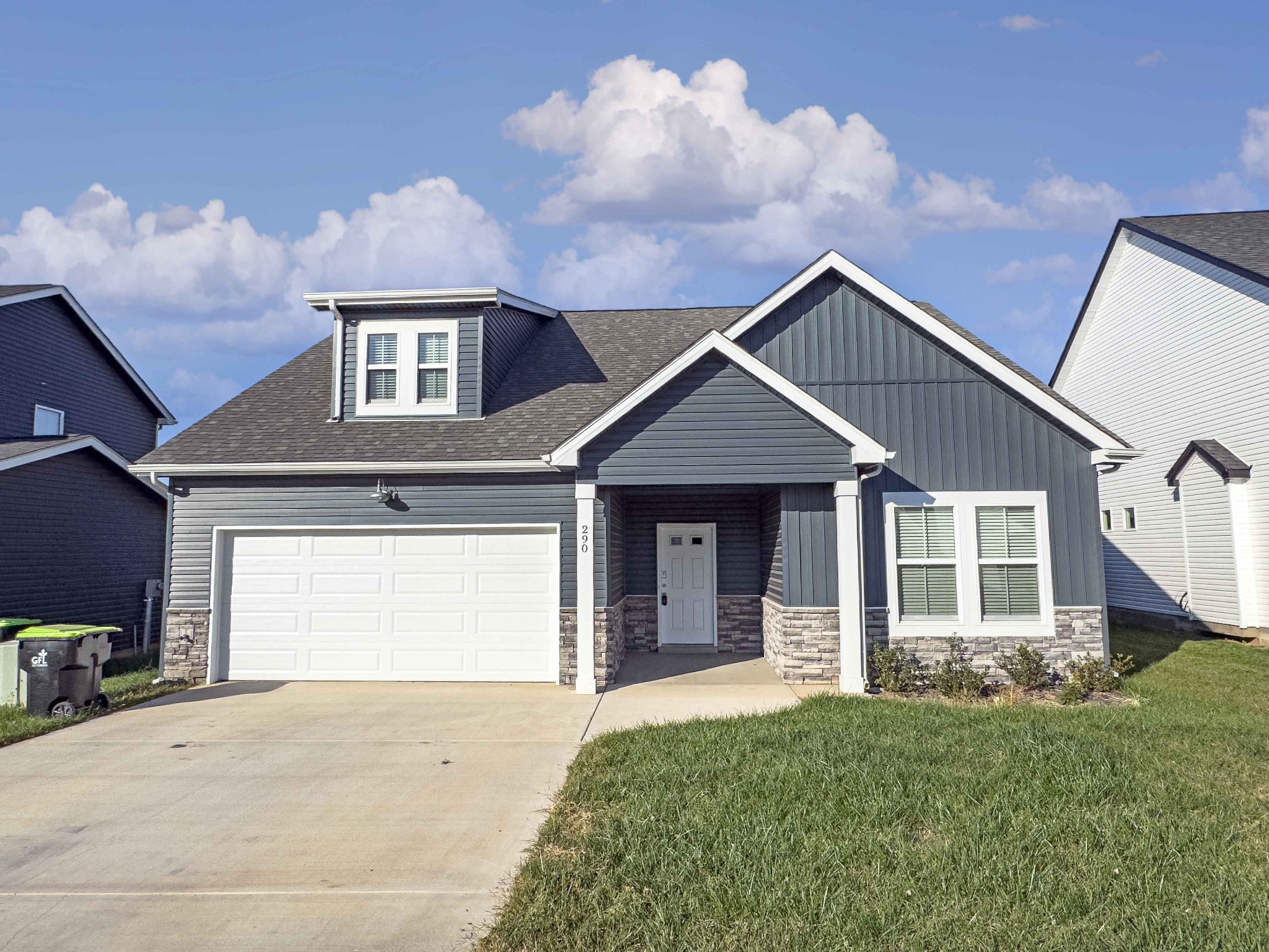 a front view of a house with a yard and garage