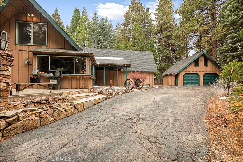 a view of house with yard and sitting area