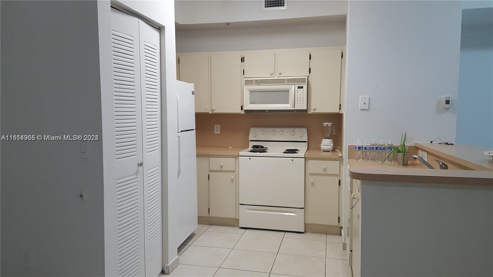 a utility room with cabinets washer and dryer