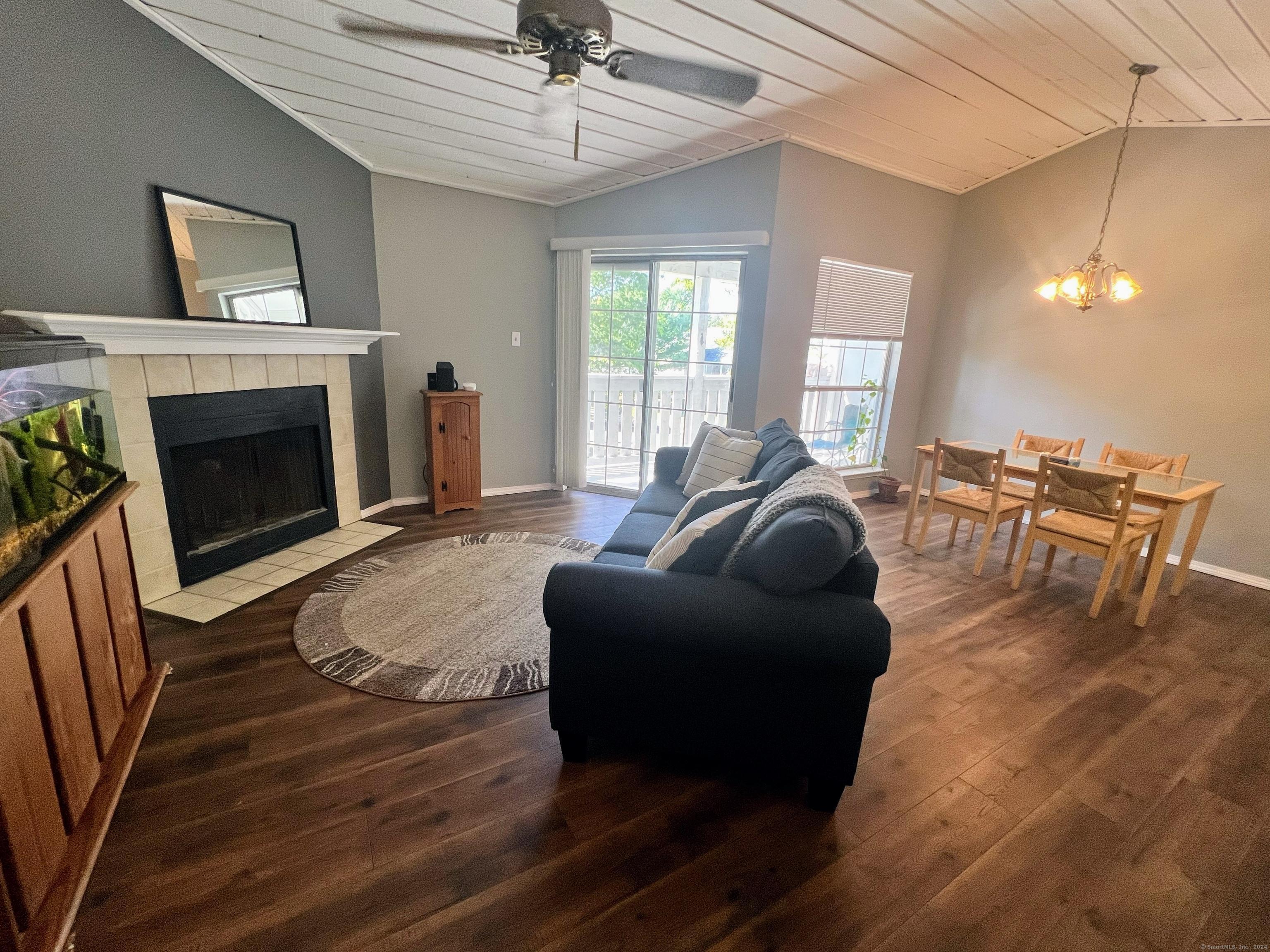 a living room with furniture a fireplace and a chandelier