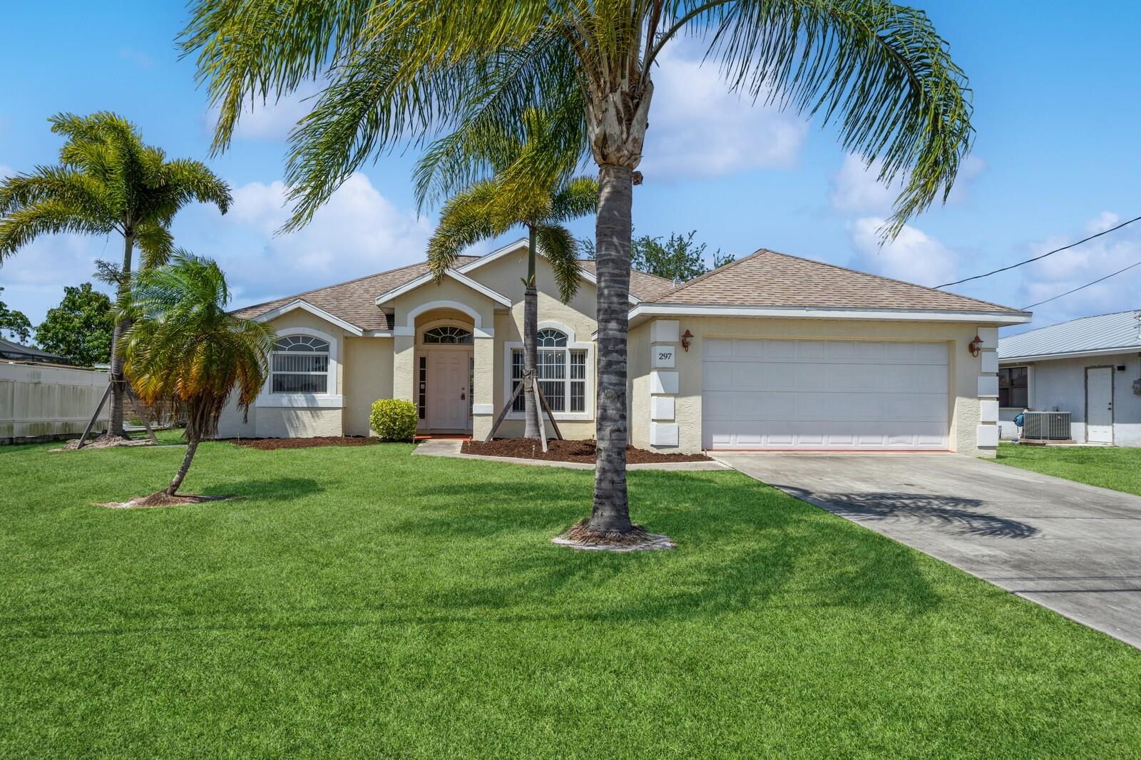 a front view of a house with a garden