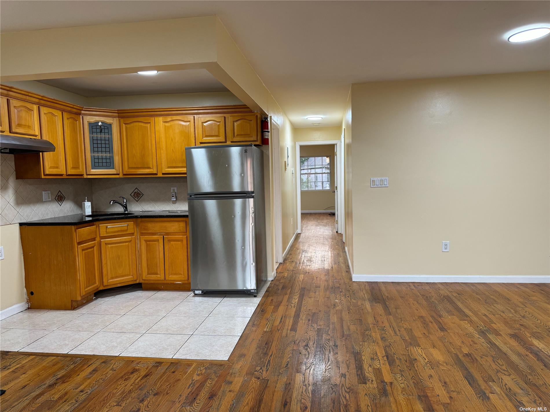 a kitchen with a refrigerator a sink and cabinets