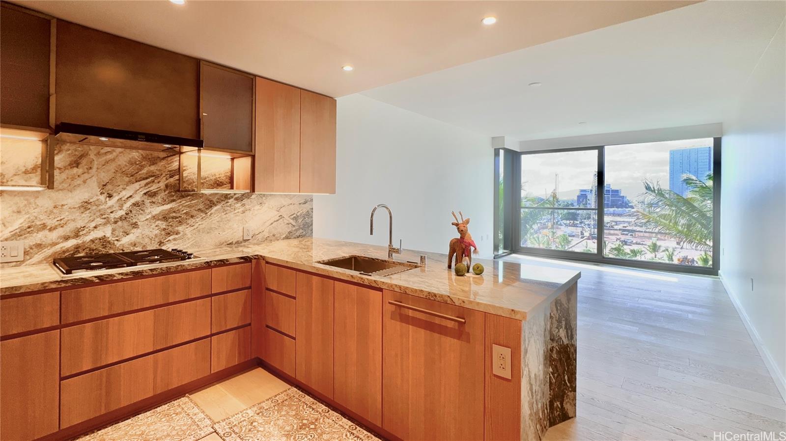 a kitchen with stainless steel appliances granite countertop a sink stove and cabinets