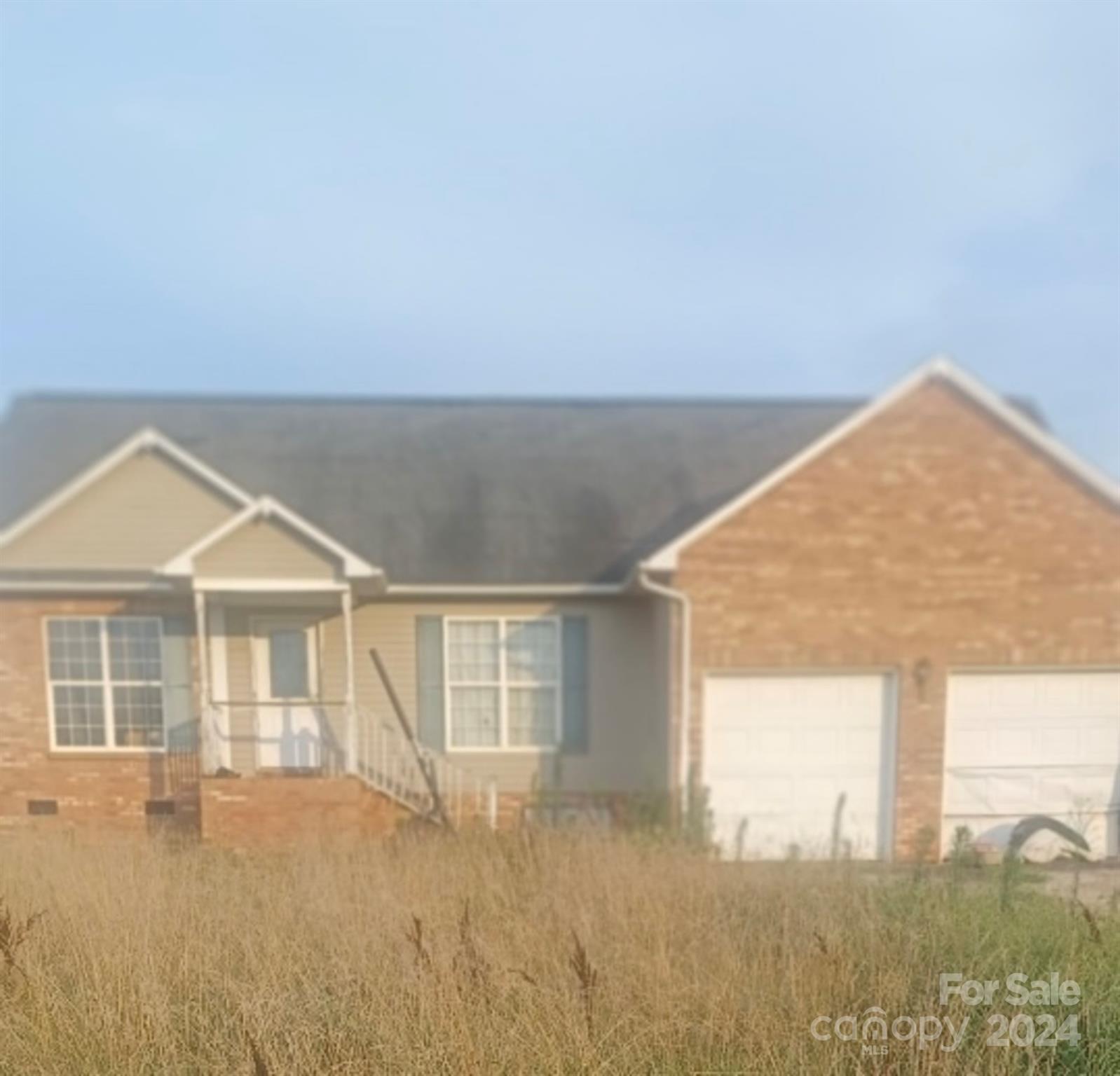 a view of a house with a backyard and a yard