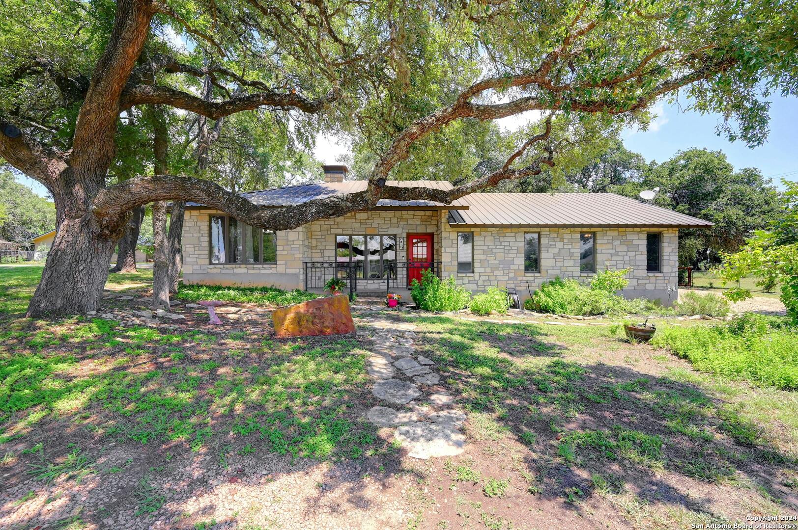 a front view of a house with yard and green space