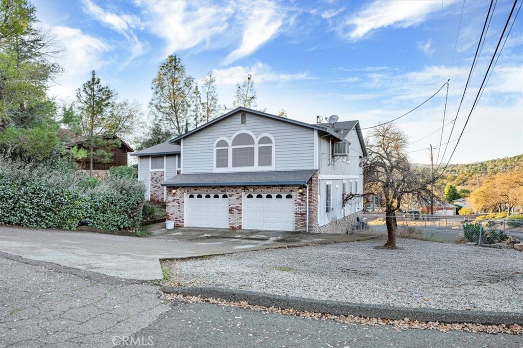 a house that has a tree in front of it