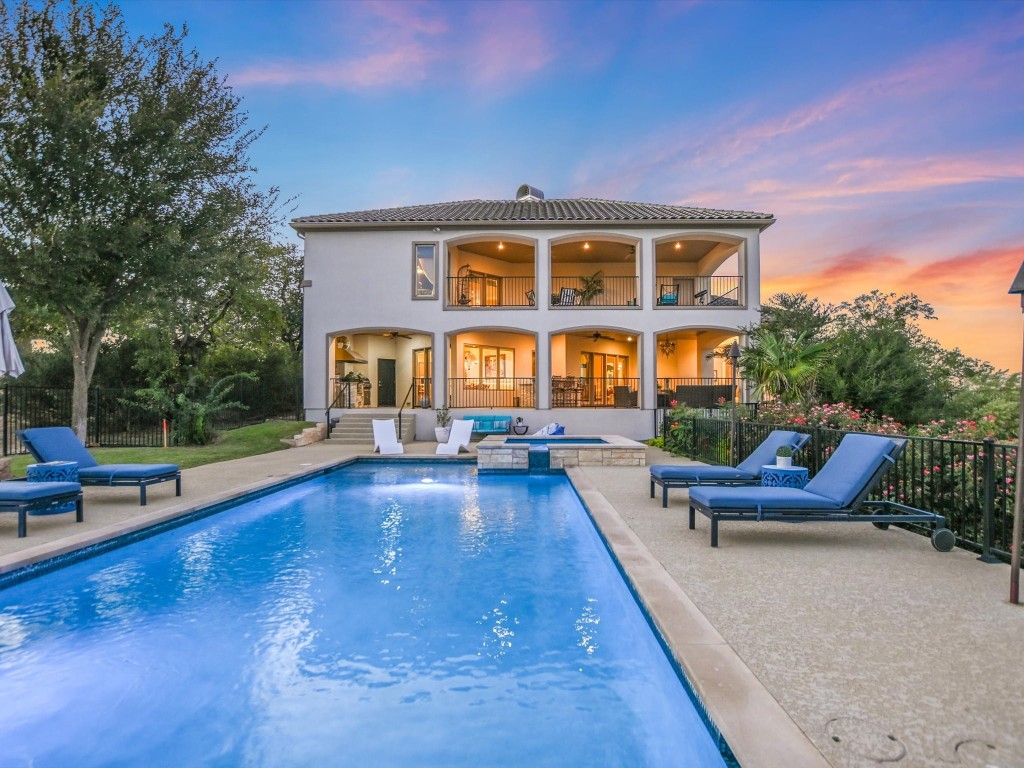 a view of a house with swimming pool and sitting area