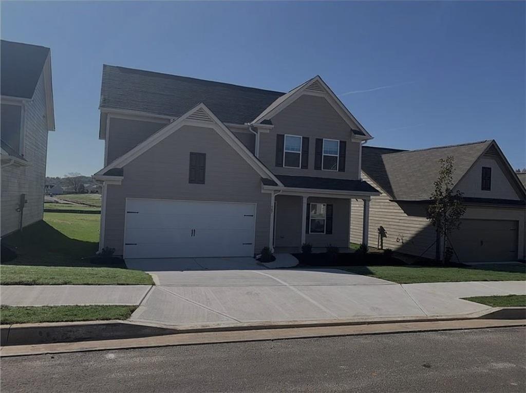 a front view of a house with a yard and garage