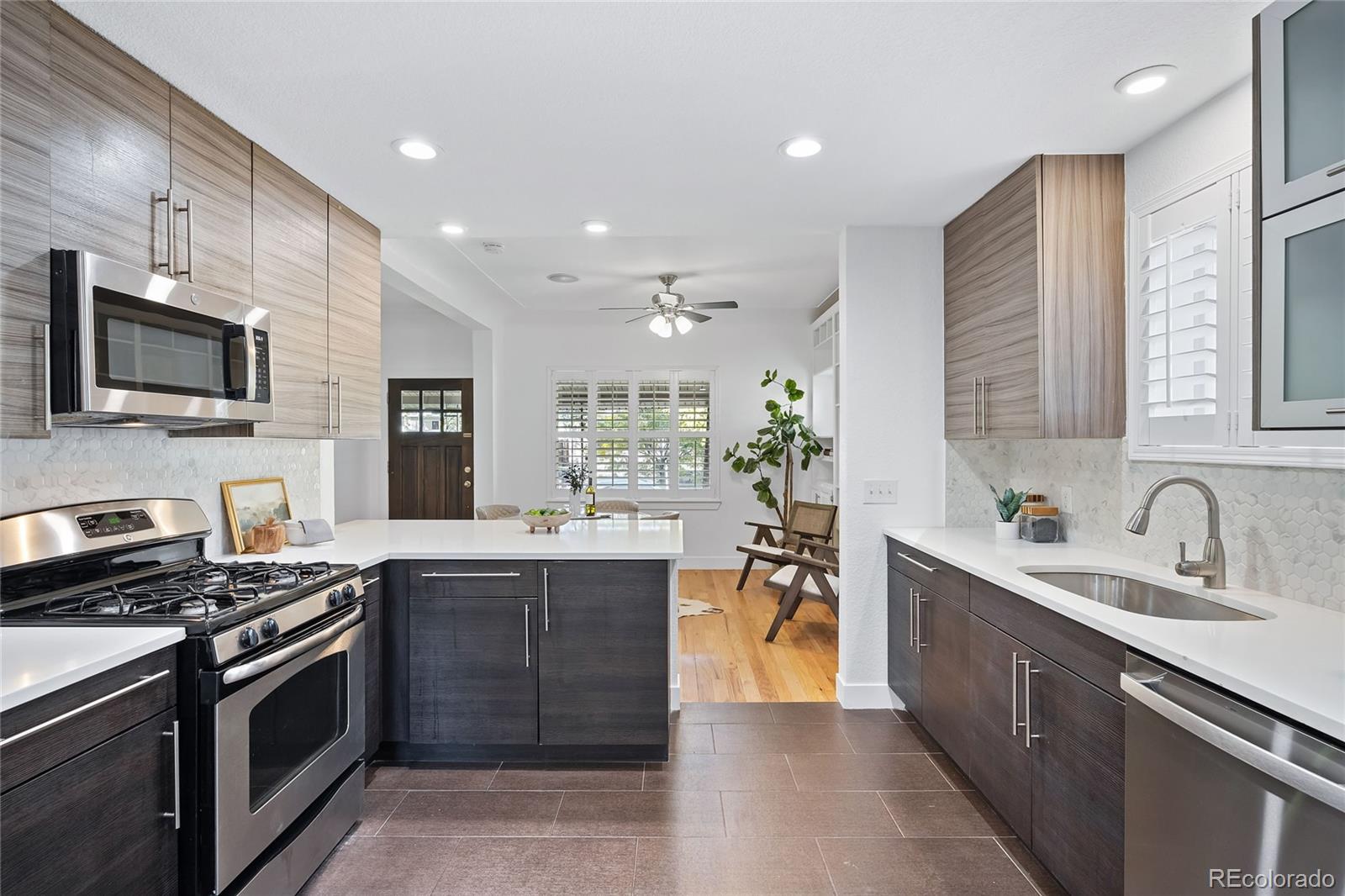 a kitchen with stainless steel appliances granite countertop a sink stove and refrigerator