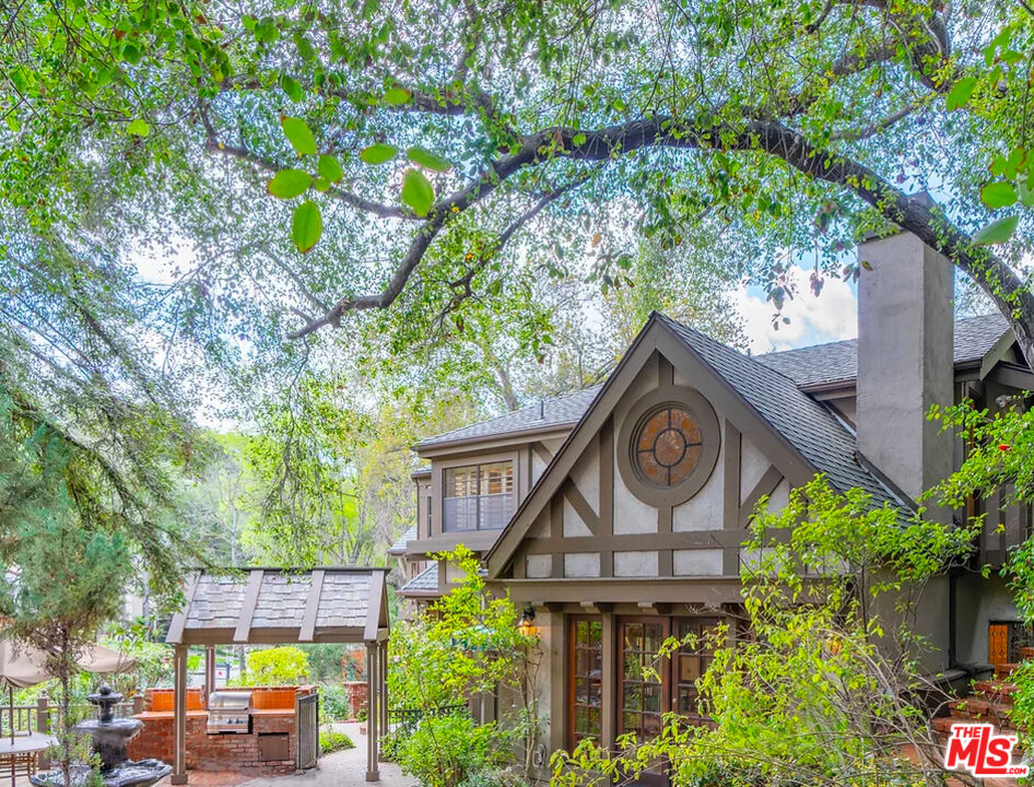 a front view of a house with a yard garage and outdoor seating