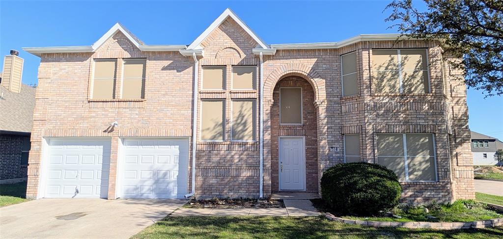 a view of a brick house with windows and entryway