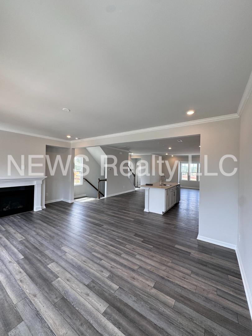 a view of livingroom and dining room with wooden floor