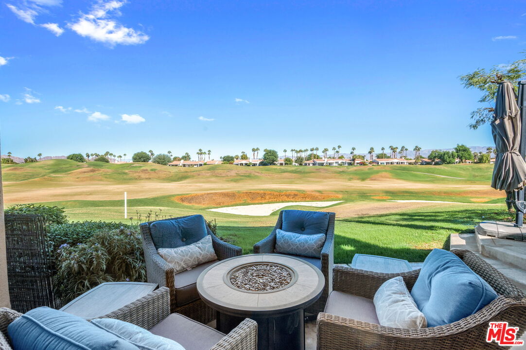 a view of a chairs and table in patio