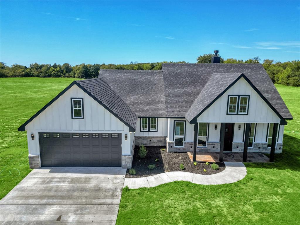 a front view of house with yard and outdoor seating