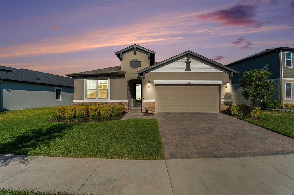 a front view of a house with a yard and garage