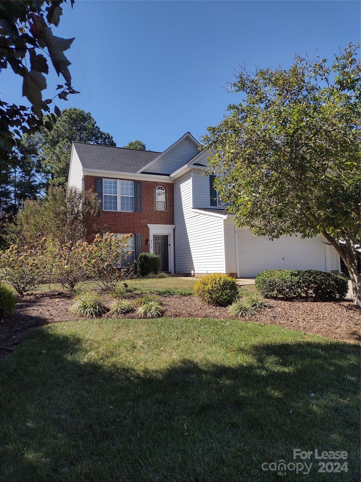 a front view of house with yard and trees