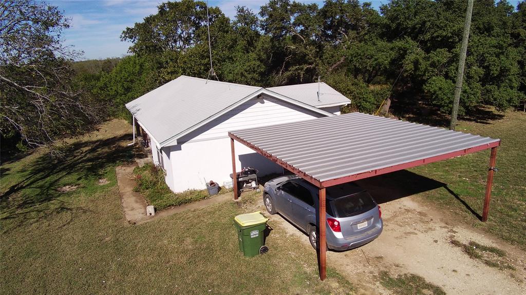 a aerial view of a house with roof deck front of house